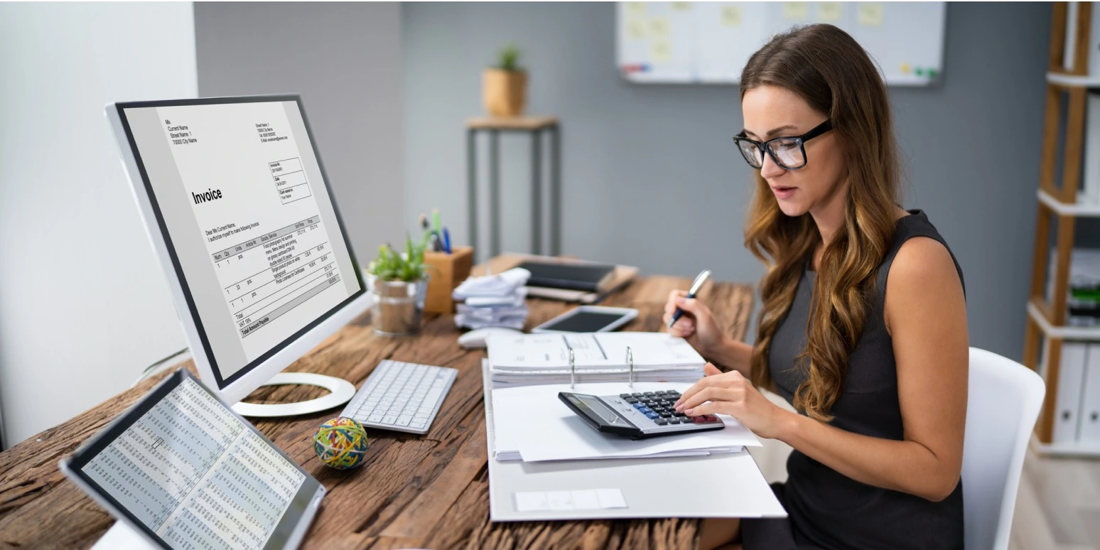 Bookkeeping concept with ledger, calculator, and financial documents on a desk